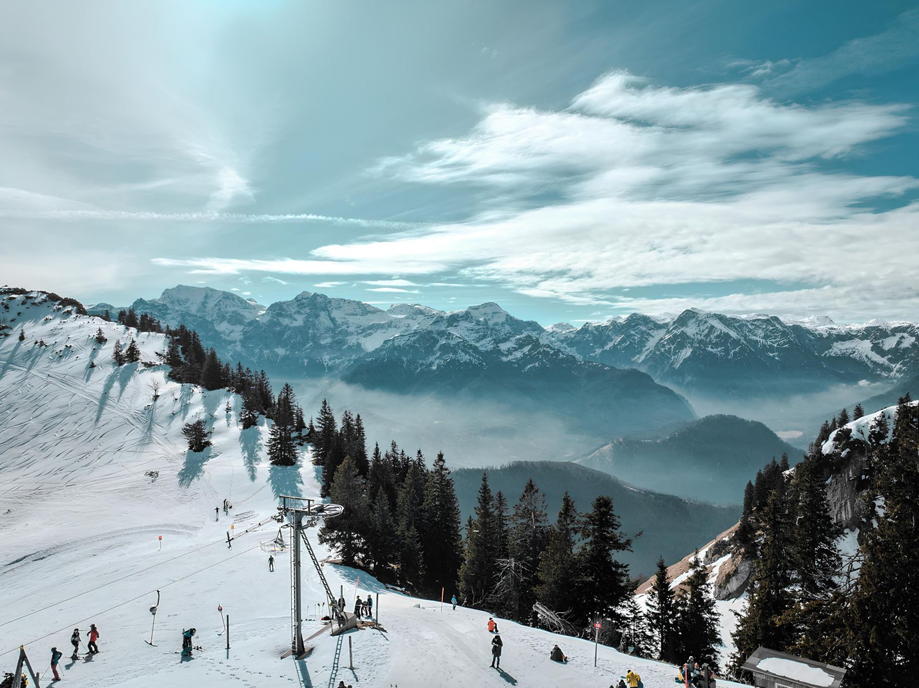 Ski field with a T-bar and snowy mountains behind